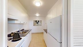 Thornhill apartment for rent - A kitchen with white cabinets and a white fridge.