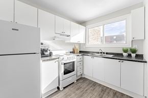 London townhouse for rent - A modern kitchen with white appliances and cabinets.