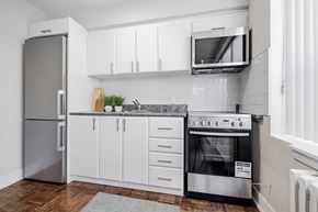Toronto apartment for rent - A modern kitchen with a stainless steel refrigerator, oven, and microwave.