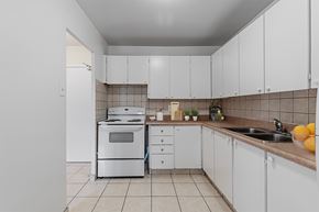 Toronto apartment for rent - A kitchen with white cabinets and a white oven.
