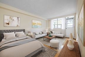 North York apartment for rent - A bedroom with a large bed and a white couch.