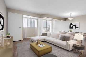 London apartment for rent - A living room with a white couch, a yellow coffee table, and a painting on the wall.