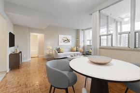 North York apartment for rent - A modern dining room with a round table and grey chairs.