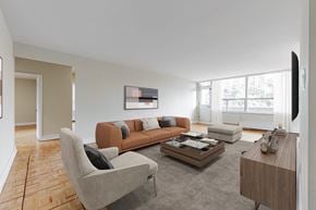 Toronto apartment for rent - A living room with a grey sofa, a grey armchair, a coffee table, and a television.