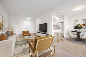 Scarborough townhouse for rent - A modern living room with a white sofa, a wooden coffee table, and a television.