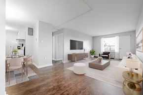 London apartment for rent - A modern living room with a dining area and a kitchen in the background.