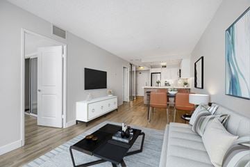 Toronto apartment for rent - A living room with a white couch and a black coffee table.