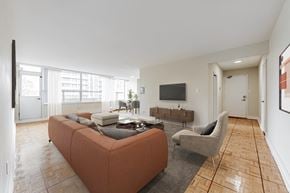 Toronto apartment for rent - A living room with a couch, chair, and television.