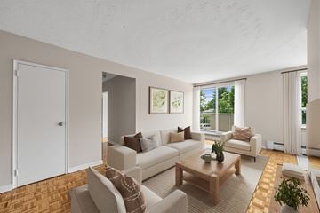 Brampton apartment for rent - A living room with a white couch and a wooden coffee table.