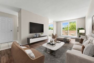 Cambridge apartment for rent - A living room with a brown chair and a white couch.