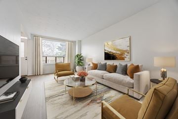 Scarborough townhouse for rent - A modern living room with a grey sofa, a coffee table, and a large painting on the wall.