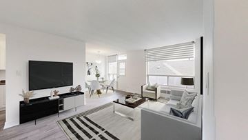 Toronto apartment for rent - A modern living room with a black television and a striped rug.