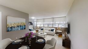 Mississauga apartment for rent - A dining room with a table set for two and a painting on the wall.