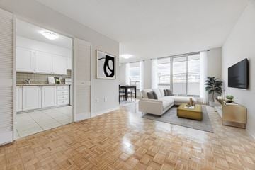 North York apartment for rent - A living room with a white couch and a yellow coffee table.