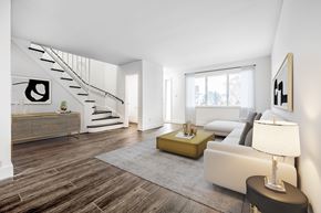 Waterloo apartment for rent - A modern living room with a staircase and a couch.