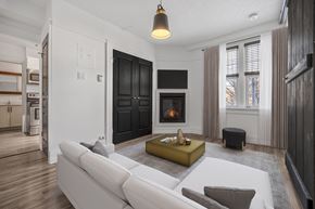 Kitchener apartment for rent - A modern living room with a fireplace and a white couch.