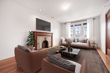 Toronto apartment for rent - A living room with a fireplace and a television above it.
