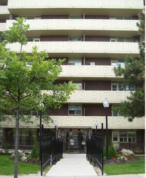 North York apartment for rent - A large building with a black gate in front.