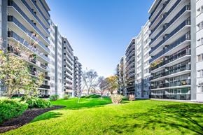 Etobicoke apartment for rent - A grassy area in front of apartment buildings.