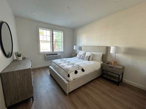 Milford apartment for rent - a bedroom with a bed and a dresser and a window