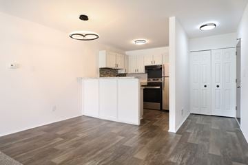 Warren apartment for rent - A kitchen with white cabinets and a wooden floor.