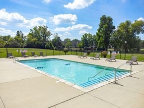 Auburn Hills apartment for rent - a swimming pool with chairs and a fence around it