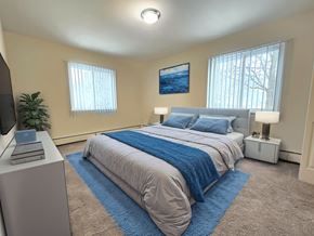Armada apartment for rent - A bedroom with a bed, a television, and a painting on the wall.