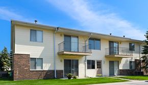 Saginaw apartment for rent - A two-story apartment building with a balcony on the second floor.