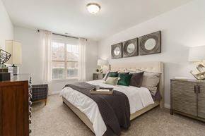 Commerce Township apartment for rent - a bedroom with a bed and two mirrors on the wall