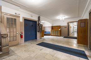 Detroit apartment for rent - the lobby of an old building with a blue door