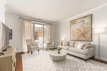 Commerce Township apartment for rent - A living room with a couch, chair, and a large painting on the wall.