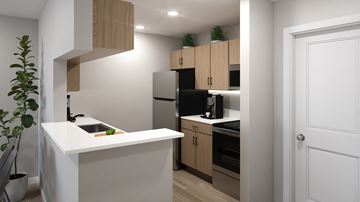 Waterford Township apartment for rent - A kitchen with a white countertop and wooden cabinets.
