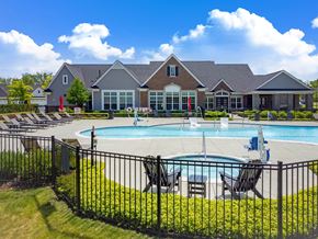 Commerce Township apartment for rent - A large house with a pool in front.