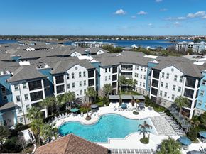 Orlando apartment for rent - A large apartment complex with a swimming pool in the foreground.