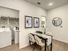 Orlando apartment for rent - a dining room with a table and chairs and a laundry room