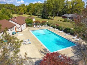 Trenton apartment for rent - A swimming pool surrounded by trees and a house.