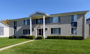 Sterling Heights apartment for rent - A grey and white two-story house with a green lawn in front.