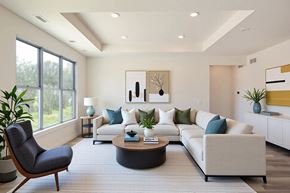 Howell apartment for rent - A modern living room with a grey chair and a white sofa.