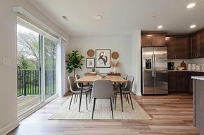 Brighton apartment for rent - A modern kitchen with a dining table and chairs in the middle of the room.