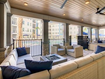 Orlando apartment for rent - A spacious living room with a white sofa and a stone fireplace.
