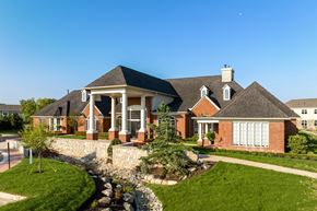 Canton apartment for rent - a large brick house with a front porch and a landscaped yard