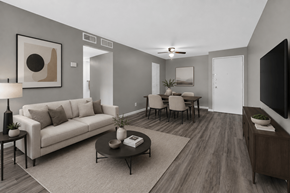 Waterford Township apartment for rent - A living room with a white couch, a coffee table, and a television.