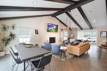 Bloomfield Hills apartment for rent - A modern living room with a large grey table and a blue sofa.