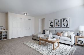 Waterford apartment for rent - A living room with a grey sofa, a wooden coffee table, and a grey rug.