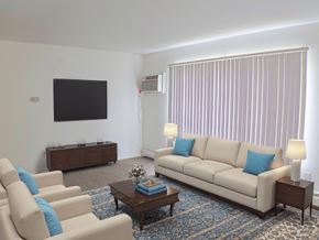 Livonia apartment for rent - A living room with a couch, chairs, and a coffee table.