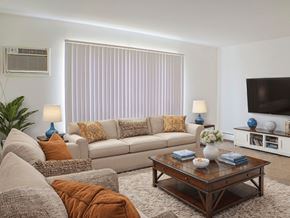 Livonia apartment for rent - A living room with a couch, coffee table, and a television.
