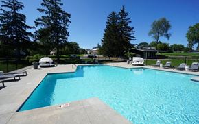 Farmington Hills townhouse for rent - a large swimming pool with chairs around it