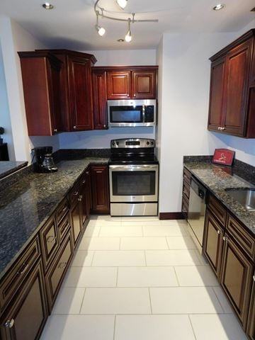 St. Louis apartment for rent - A kitchen with dark wood cabinets and granite countertops.