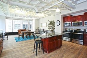 St. Louis townhouse for rent - A kitchen with wooden floors and a large island in the middle.