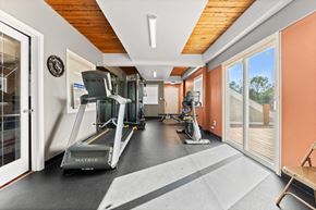 Peoria apartment for rent - A gym with a treadmill, elliptical trainer and a stationary bike.